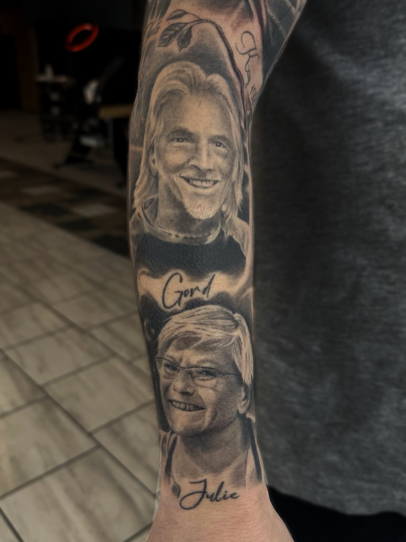 Black and grey realism portrait sleeve of two smiling family members labelled Gord and Julie